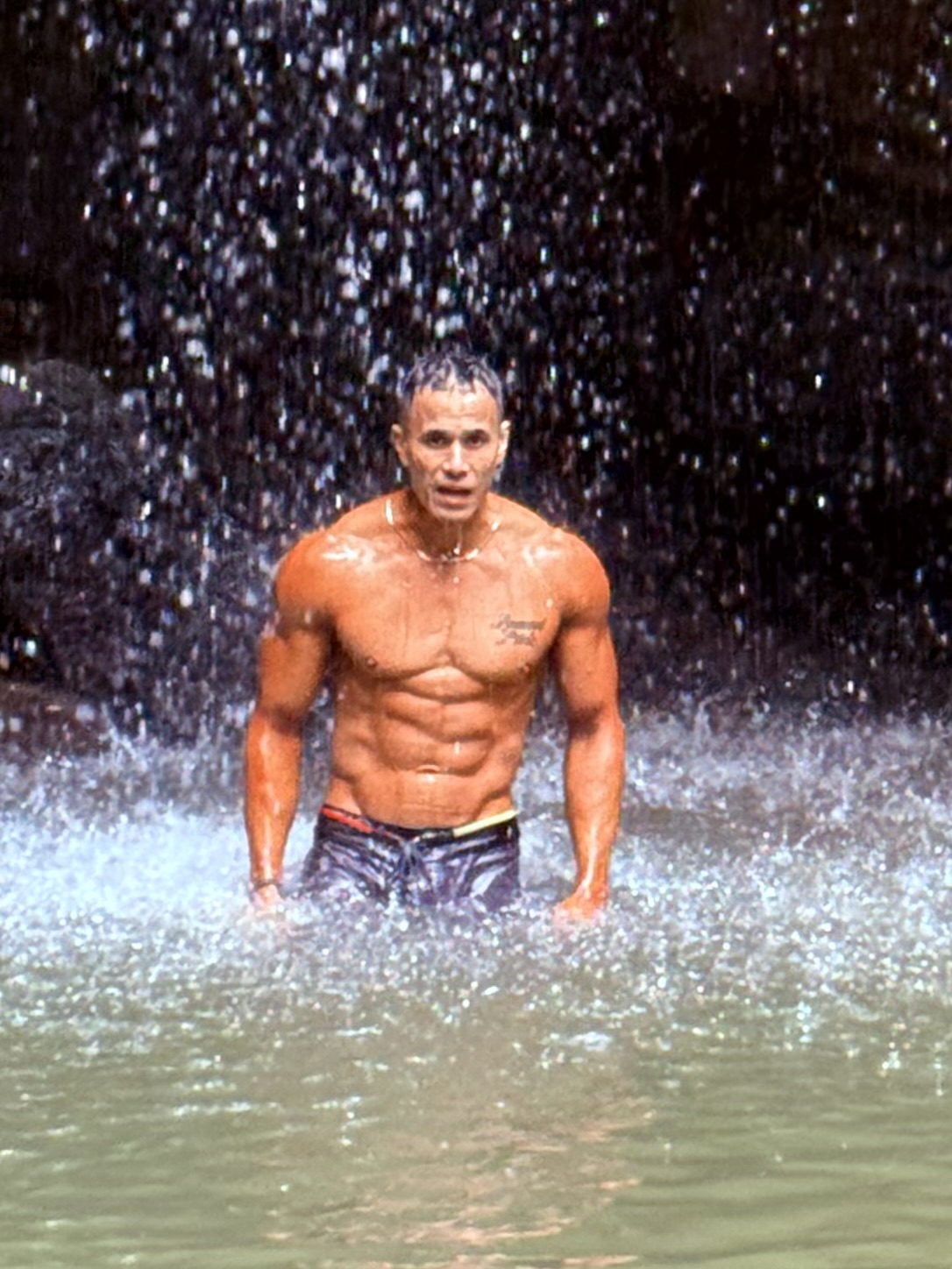 Casey standing beneath a waterfall in late September 2025, after his transformation